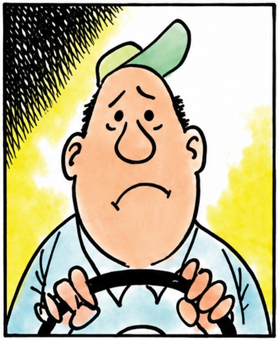 Man in a cap holding a steering wheel